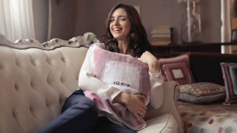 Woman sitting on couch in beatiful home