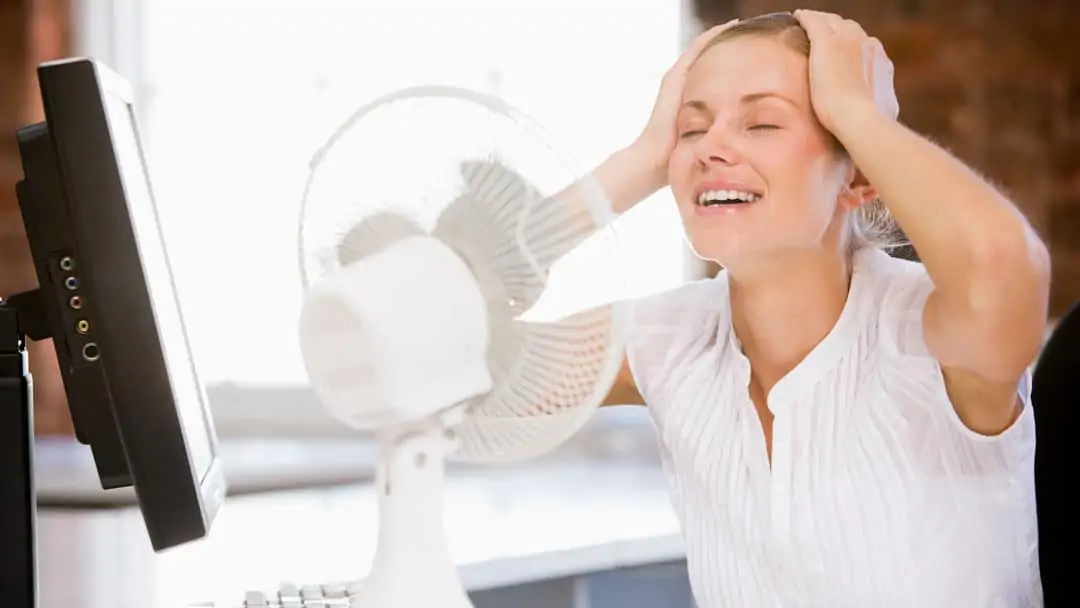 Lady trying to get cool in front of a fan