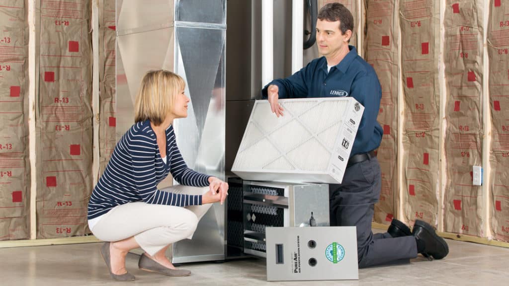 Technician installing a furnace filter