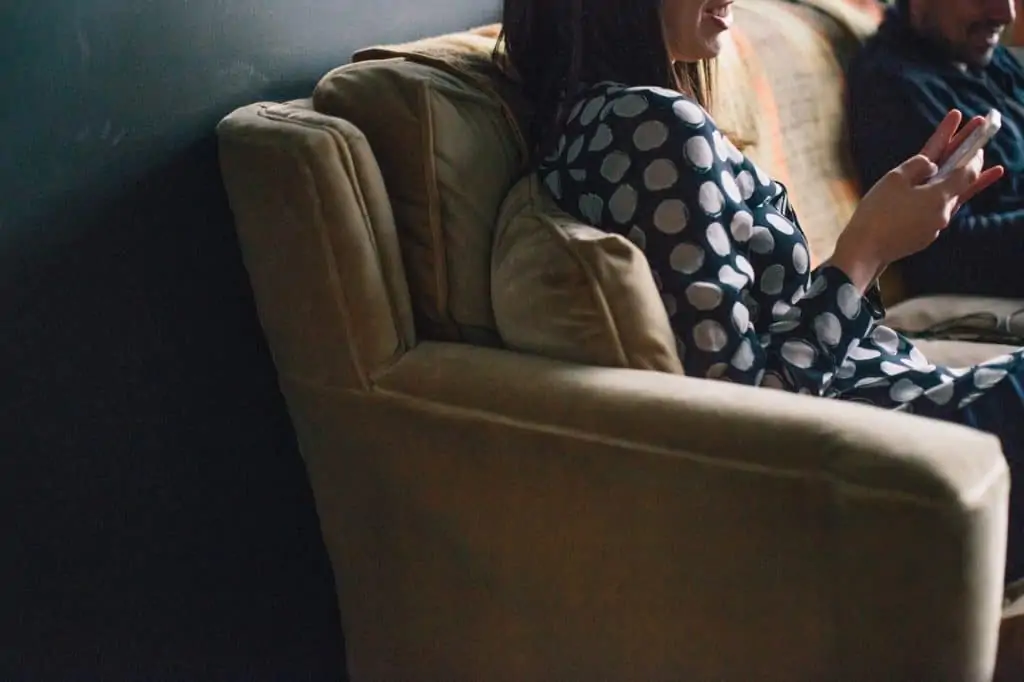 Couple sitting on couch in warm home