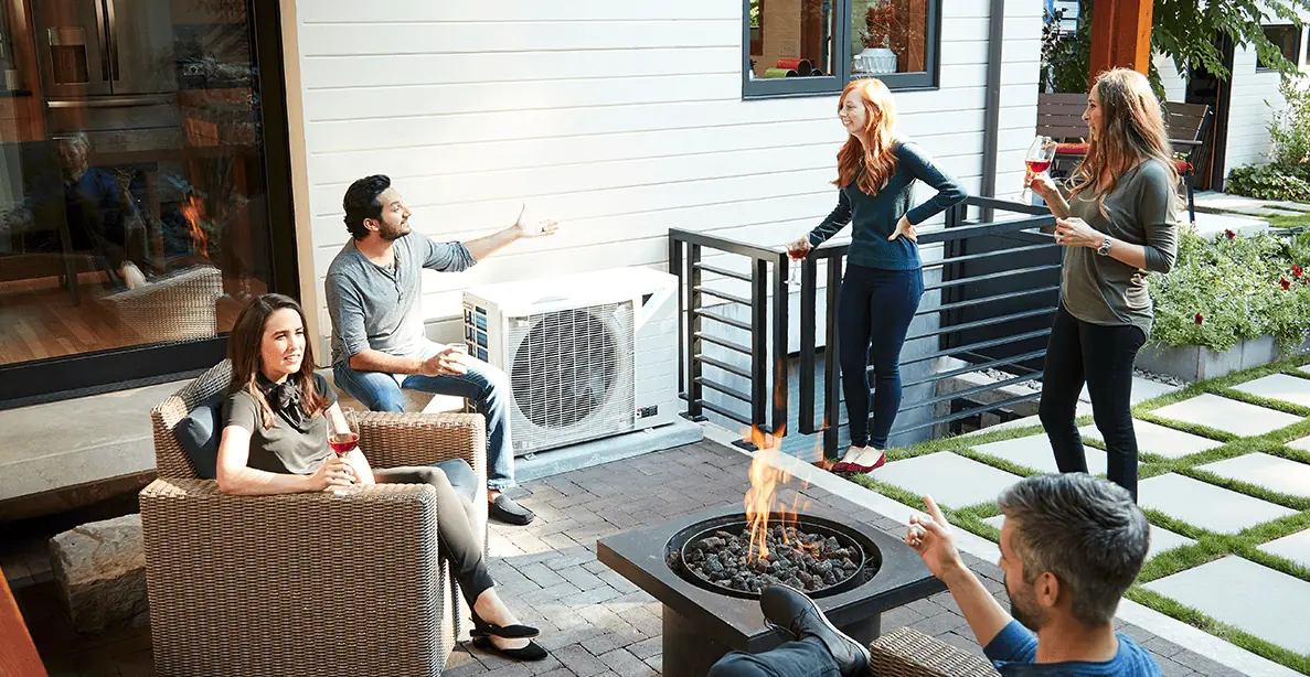 People sitting outside around a Daikin Fit air conditioner