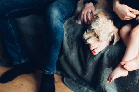 Woman on the couch with her pet dog