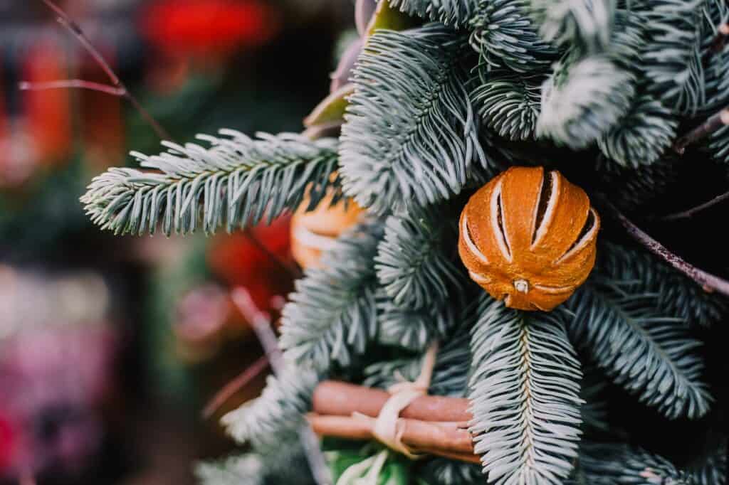 Decorated Christmas tree with festive ornaments, safely set up indoors for the holiday season.